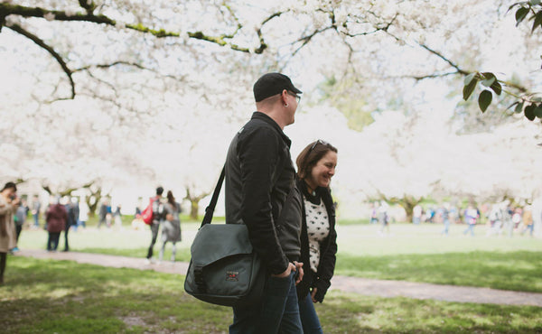 A person carrying a Maker's Bag at a park.